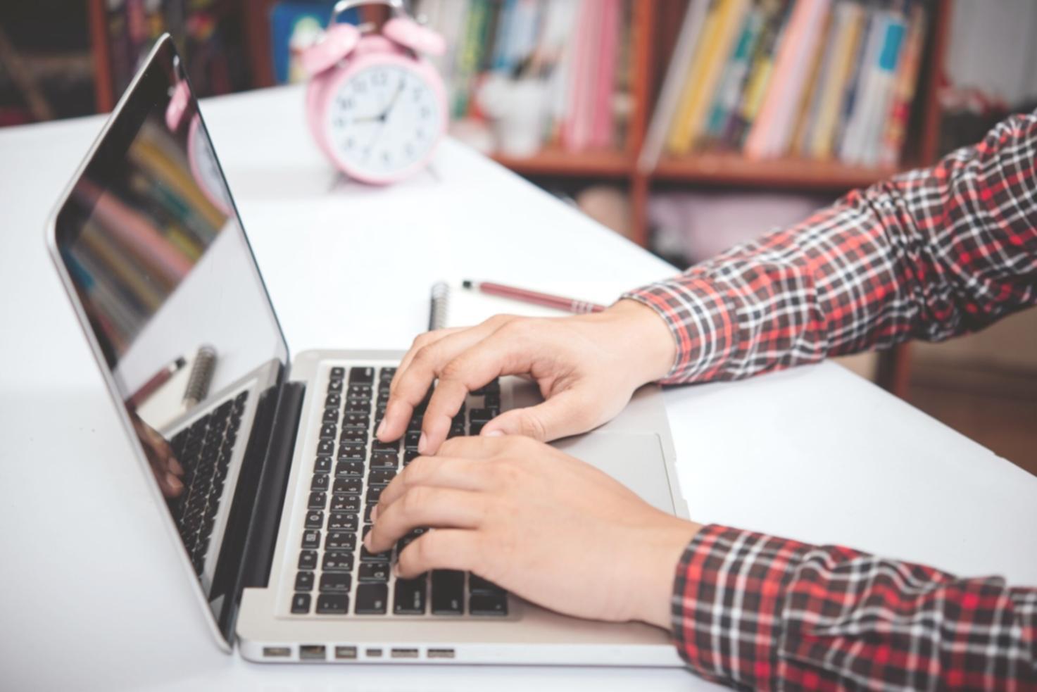 Students working on investment analysis projects using modern financial software and data visualization tools